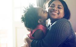 Mother hugging daughter