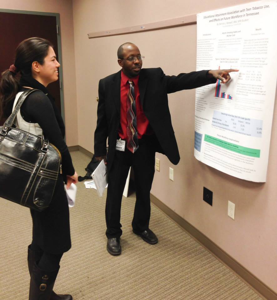 Photo of MPA student showing poster at TN-ASPA symposium