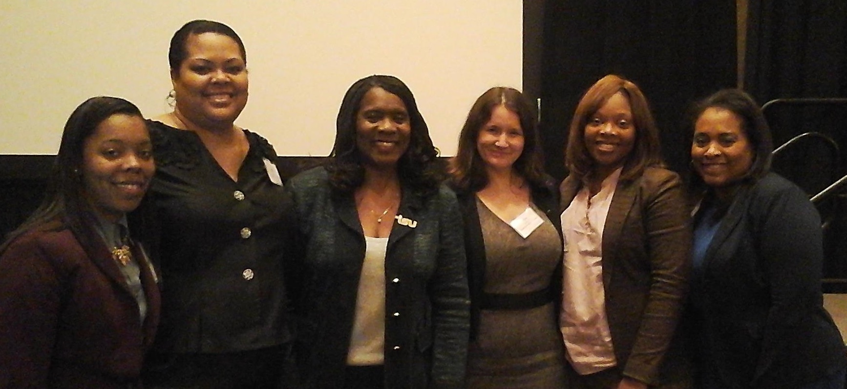 photo of President Glover with faculty and students at housing conference