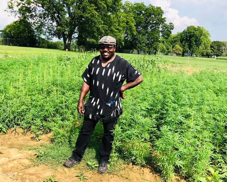 Dr. Omondi in a field of fiber hemp